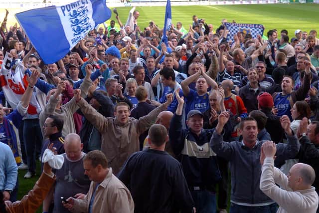 Travelling fans invade the pitch at Wigan after Pompey pull off the Great Escape in 2006.