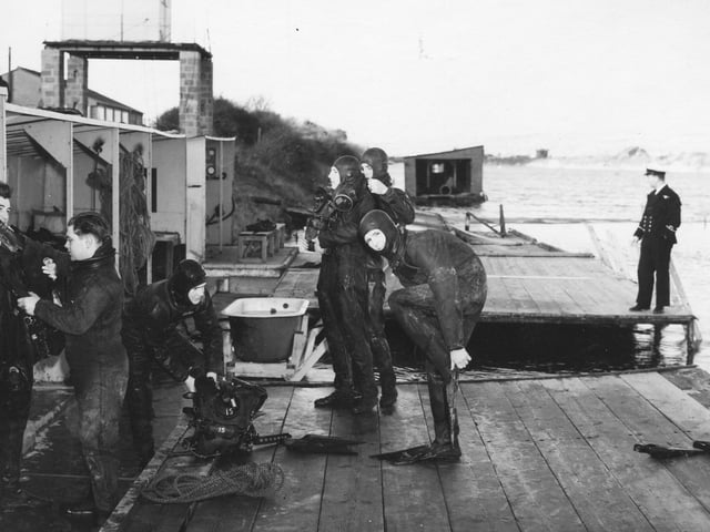 Divers just coming out of the sea by Horsea Island in 1970. The News PP4839