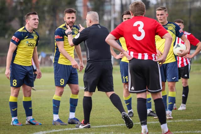 Moneyfields pair Callum Glen, left, and Dec Seiden protest to the referee after Joe Briggs had been brought down on the edge of the penalty area against Shaftesbury. Picture: Paul Collins
