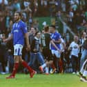 Plymouth fans invade the Home Park pitch after the Pilgrims' League Two play-off semi-final win over Pompey in 2016 as Enda Stevens, right, and Christian Burgess attempt to get off the pitch