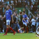 Plymouth fans invade the Home Park pitch after the Pilgrims' League Two play-off semi-final win over Pompey in 2016 as Enda Stevens, right, and Christian Burgess attempt to get off the pitch