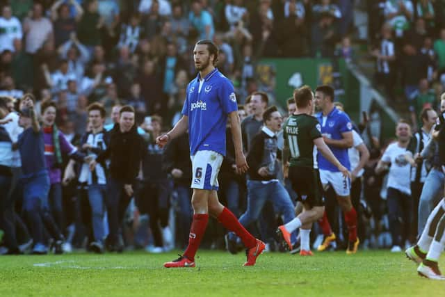 Plymouth fans invade the Home Park pitch after the Pilgrims' League Two play-off semi-final win over Pompey in 2016 as Enda Stevens, right, and Christian Burgess attempt to get off the pitch