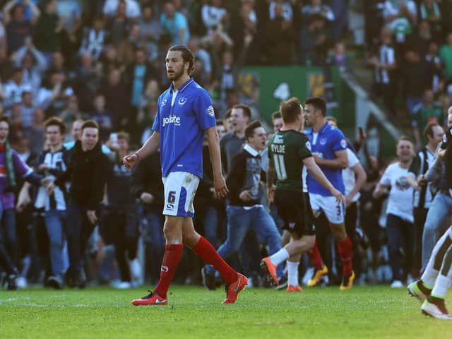 Plymouth fans invade the Home Park pitch after the Pilgrims' League Two play-off semi-final win over Pompey in 2016 as Enda Stevens, right, and Christian Burgess attempt to get off the pitch