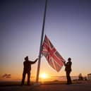 Retired Wing Commander Steve Dean (right), project manager for the British Normandy Memorial, and Myles Hunt (left) Head Gardener raise the Union Flag at sunrise to mark the 78th anniversary of D-Day at The British Normandy Memorial overlooking Gold Beach on June 06, 2022 in Ver-sur-Mer, France. A commemoration for the 80th anniversary of D-Day  in 2024 will be held at the memorial. The MoD said other events will take place across the UK, but has not confirmed the locations - raising questions about Portsmouth's involvement. (Photo by Kiran Ridley)