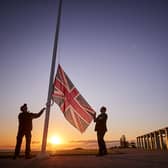Retired Wing Commander Steve Dean (right), project manager for the British Normandy Memorial, and Myles Hunt (left) Head Gardener raise the Union Flag at sunrise to mark the 78th anniversary of D-Day at The British Normandy Memorial overlooking Gold Beach on June 06, 2022 in Ver-sur-Mer, France. A commemoration for the 80th anniversary of D-Day  in 2024 will be held at the memorial. The MoD said other events will take place across the UK, but has not confirmed the locations - raising questions about Portsmouth's involvement. (Photo by Kiran Ridley)