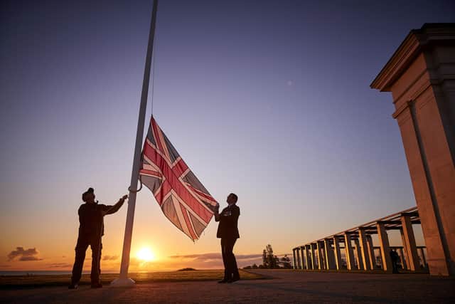 Retired Wing Commander Steve Dean (right), project manager for the British Normandy Memorial, and Myles Hunt (left) Head Gardener raise the Union Flag at sunrise to mark the 78th anniversary of D-Day at The British Normandy Memorial overlooking Gold Beach on June 06, 2022 in Ver-sur-Mer, France. A commemoration for the 80th anniversary of D-Day  in 2024 will be held at the memorial. The MoD said other events will take place across the UK, but has not confirmed the locations - raising questions about Portsmouth's involvement. (Photo by Kiran Ridley)