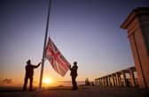 Retired Wing Commander Steve Dean (right), project manager for the British Normandy Memorial, and Myles Hunt (left) Head Gardener raise the Union Flag at sunrise to mark the 78th anniversary of D-Day at The British Normandy Memorial overlooking Gold Beach on June 06, 2022 in Ver-sur-Mer, France. A commemoration for the 80th anniversary of D-Day  in 2024 will be held at the memorial. The MoD said other events will take place across the UK, but has not confirmed the locations - raising questions about Portsmouth's involvement. (Photo by Kiran Ridley)