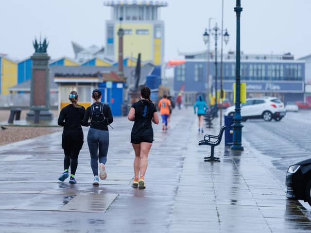 Runners hitting the streets in wet and windy conditions despite The Great South Run being cancelled last year. 