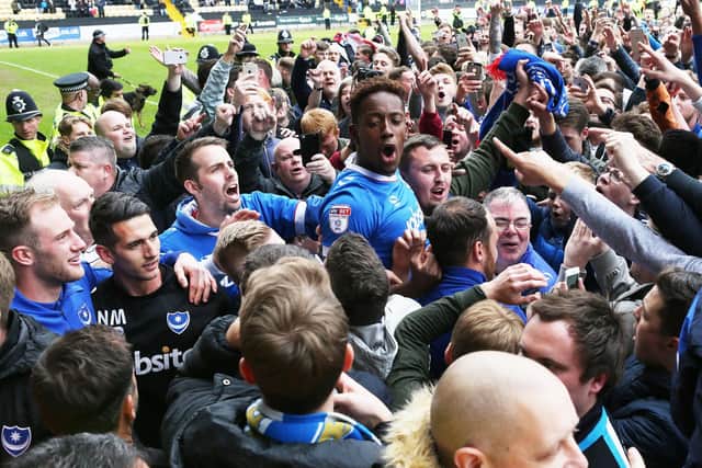 Goal hero Jamal Lowe was carried off the pitch at Notts County after earning Pompey promotion from League Two in April 2017. Picture: Joe Pepler
