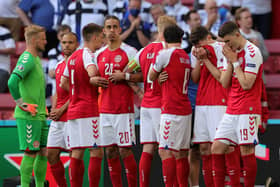 The Denmark players formed a protect wall around Christian Eriksen as he received treatment on the pitch during yesterday's game with Finland.  Picture: Friedemann Vogel - Pool/Getty Images