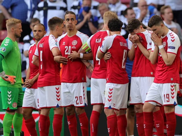 The Denmark players formed a protect wall around Christian Eriksen as he received treatment on the pitch during yesterday's game with Finland.  Picture: Friedemann Vogel - Pool/Getty Images