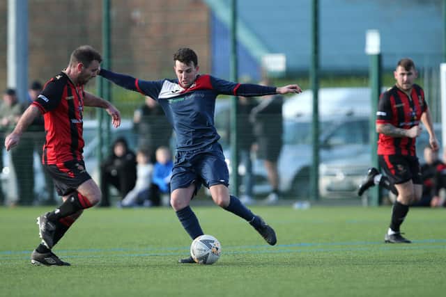 Jimmy Hird (blue) in action for Paulsgrove during their 4-2 Hampshire Premier League win at Fleetlands in February 2020 - the last time the clubs met. Picture: Chris Moorhouse