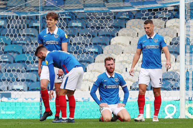 Doncaster's Reece James scores his first goal of the match passed Portsmouth's Craig MacGillivray and Portsmouth's Tom Naylor dejected