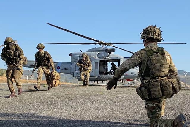 British Army reservists from 106 Regiment, Royal Artillery, run from a helicopter in Cyprus during their annual training camp in May. Photo: Tom Cotterill