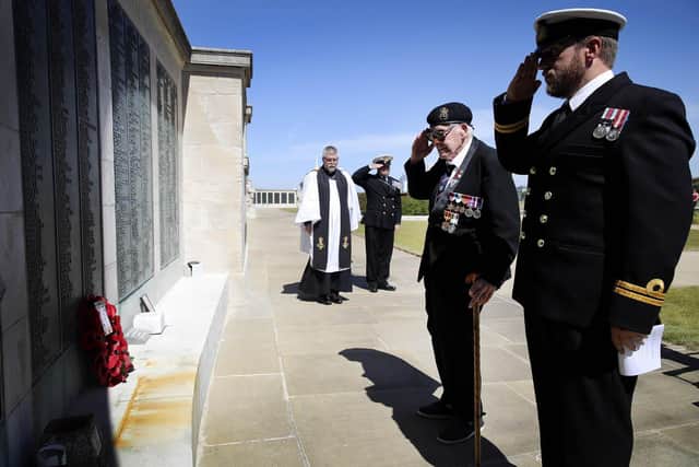 Lawrence Churcher, 99, pictured saluting with Lieutenant Calvin Shenton (right). Photo: PO Arron Hoare