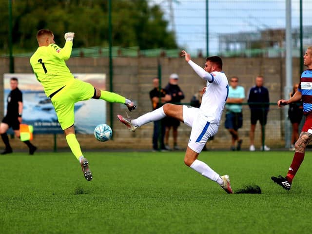 Gosport striker Harvey Bradbury (middle) in FA Cup action at Hamworthy. Picture by Tom Phillips