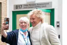 Sir Rod Stewart poses for photos with members of staff at the Princess Alexandra Hospital in Harlow, Essex