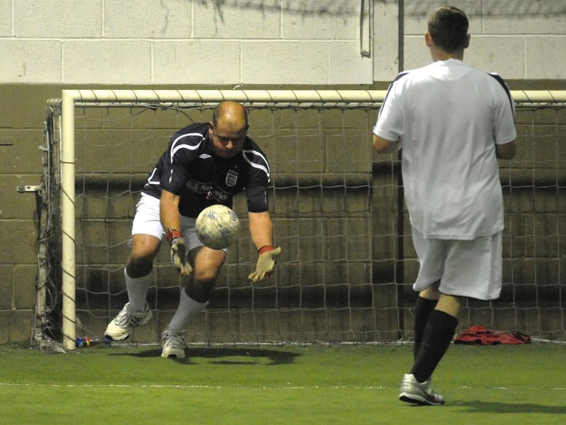 The B Sliders keeper collects the ball during his team's game against Oblivion.