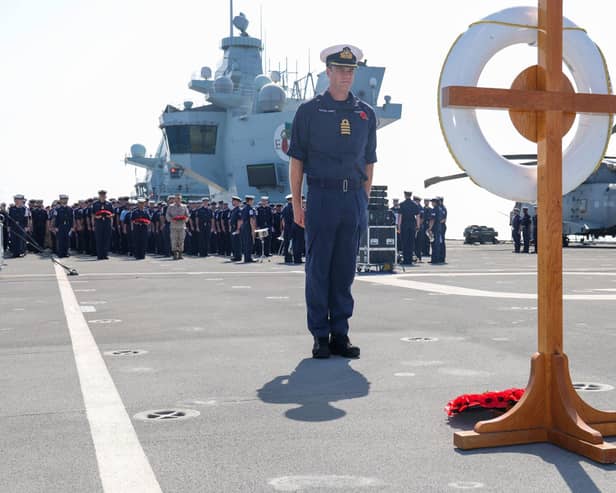 Handout photo issued by the Ministry of Defence (MoD) of Captain Ian Feasey, Commanding Officer HMS Queen Elizabeth, after he laid a wreath during a Remembrance Sunday service on the flight deck of HMS Queen Elizabeth, whilst on deployment with the Carrier Strike Group 21(CSG21) as part of Operation Fortis. Picture date: Sunday November 14, 2021.