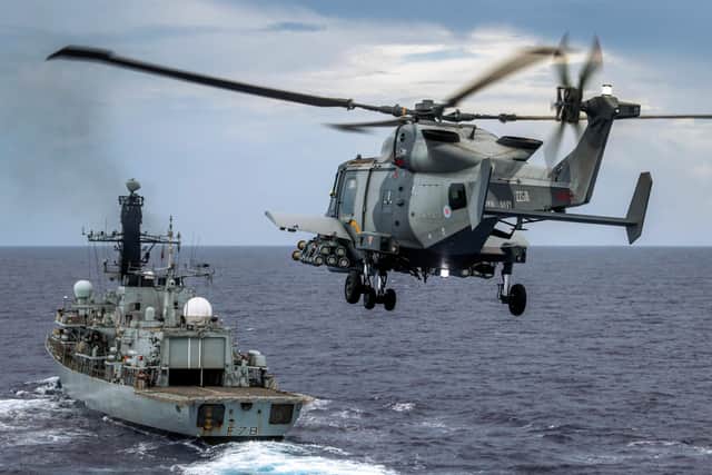 Pictured: HMS Defender's Wildcat HMA Mk 2 helicopter conducts a fly past HMS Kent with her Martlet wings attached whilst in the Indo-Pacific region.