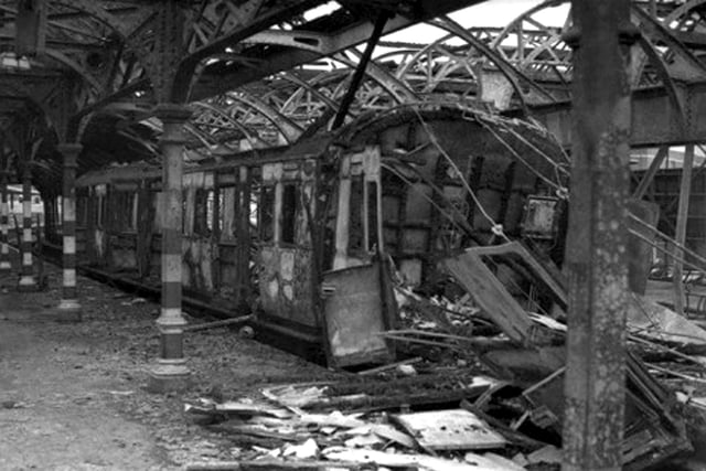 Ruination at Portsmouth Harbour Station.
Taken from  Southern Way-Wartime Southern here we see a burnt out carriage at the Portsmouth Harbour Station after a raid on August 12, 1940. The roof supports have been painted black and white for better sightseeing in the blackout. In this raid four trains were destroyed and the  Isle of Wight landing stage was gutted. One man was killed.