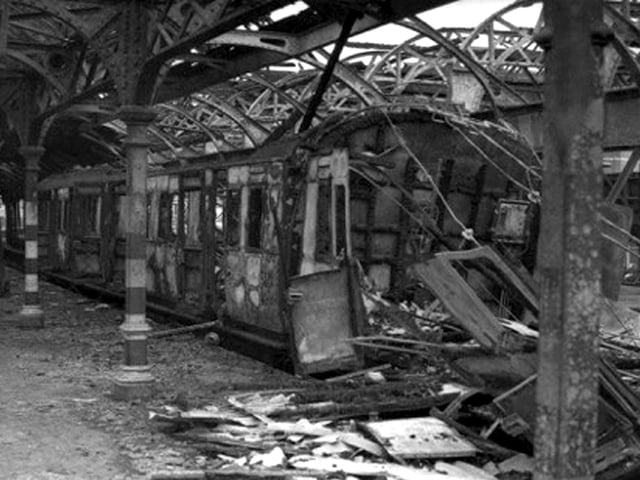 Ruination at Portsmouth Harbour Station.
Taken from Southern Way-Wartime Southern here we see a burnt out carriage at the Portsmouth Harbour Station after a raid on August 12, 1940. The roof supports have been painted black and white for better sightseeing in the blackout. In this raid four trains were destroyed and the Isle of Wight landing stage was gutted. One man was killed.
