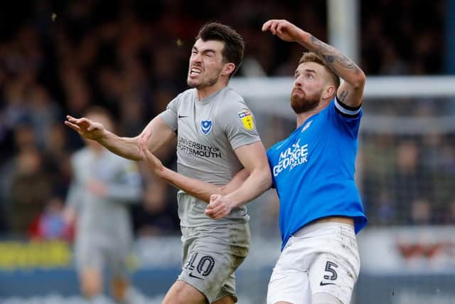 Pompey forward John Marquis battles with Peterborough United defender Mark Beevers. Picture: Simon Davies