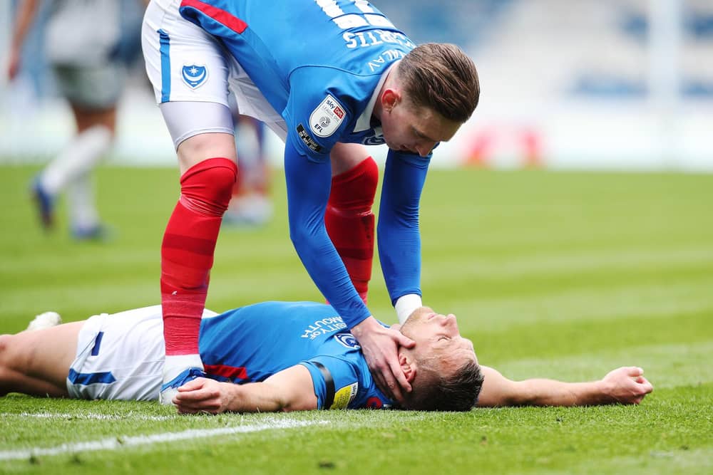 Ronan Curtis checks on Lee Brown after his team-mate suffered a hamstring injury in Saturday's 2-1 defeat to Burton. Picture: Joe Pepler