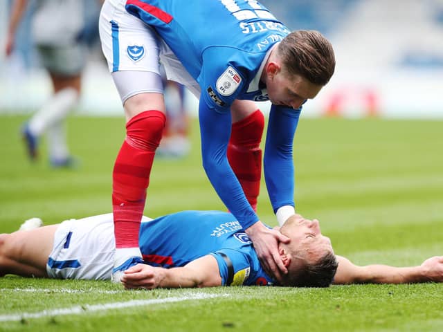 Ronan Curtis checks on Lee Brown after his team-mate suffered a hamstring injury in Saturday's 2-1 defeat to Burton. Picture: Joe Pepler