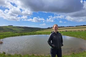 Park ranger Sophie Brown next to a restored dew pond near Arundel.  

Jeff Travis/PA Wire