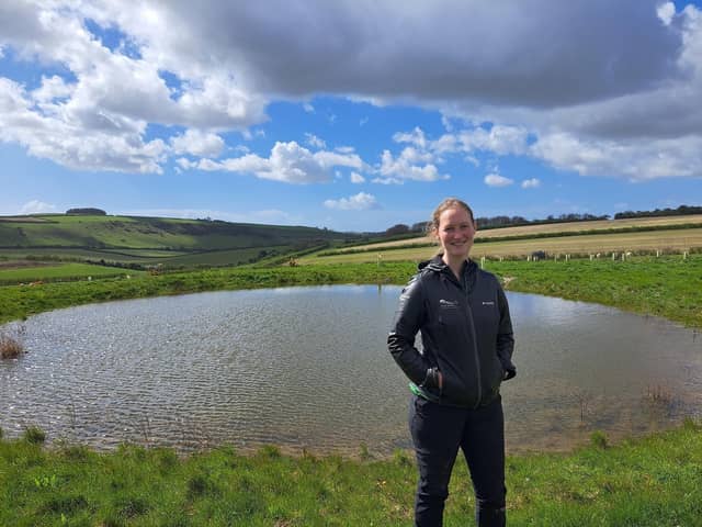 Park ranger Sophie Brown next to a restored dew pond near Arundel.  

Jeff Travis/PA Wire