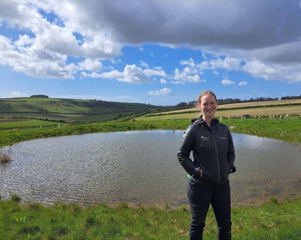 Park ranger Sophie Brown next to a restored dew pond near Arundel.  

Jeff Travis/PA Wire