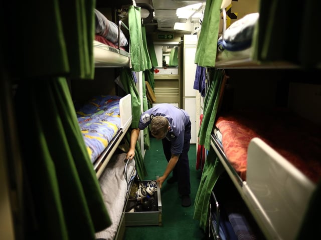 Sailor LA(SE) Bland looks through a drawer in his mess on HMS Illustrious May 10, 2013. Photo by Dan Kitwood/Getty Images