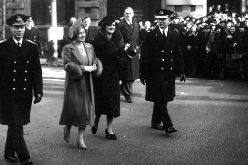 King George VI and Queen Elizabeth walking down a bomb damaged street in Portsmouth with Lord Mayor Sir Denis Daley and local dignitaries and military personnel. In the background are members of the Civil Defence. Picture: Portsmouth Museums and Records Service