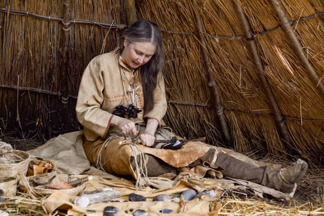Jo Shorter, a volunteer at Butser Ancient Farm, giving a demonstration of stone age skills