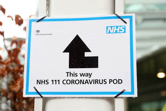 A sign directs patients towards an NHS 111 Coronavirus (COVID-19) Pod. Picture: ISABEL INFANTES/AFP via Getty Images
