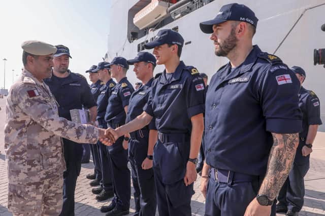 A Qatari Emiri naval Forces officer greeting Royal Navy staff.
