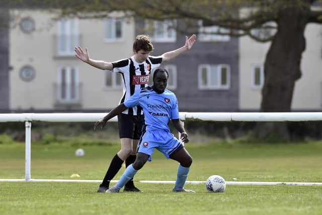 Elliott Hewson (Hayling) shadows a Portchester U23 player. Picture: Allan Hutchings