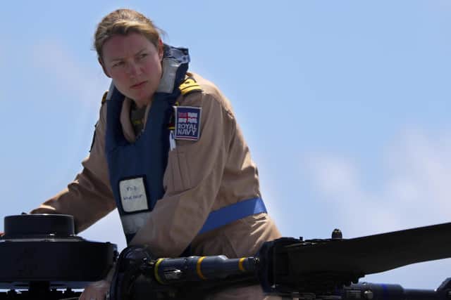 Pictured is Lt Cdr Amy Gilmore carrying out pre-flight checks on the Wildcat. She is to be made an MBE.