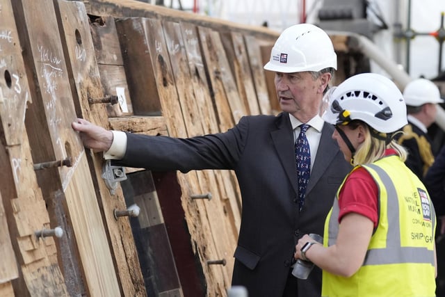 Vice Admiral Sir Tim Laurence speaks to a shipwright during a visit to see the HMS Victory Conservation Project at the National Museum of the Royal Navy in Portsmouth Historic Dockyard.