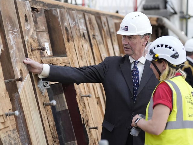 Vice Admiral Sir Tim Laurence speaks to a shipwright during a visit to see the HMS Victory Conservation Project at the National Museum of the Royal Navy in Portsmouth Historic Dockyard.