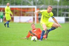 Portchester's Jake Raine, left, tackles Horndean skipper Ash Howes. Picture: Martyn White