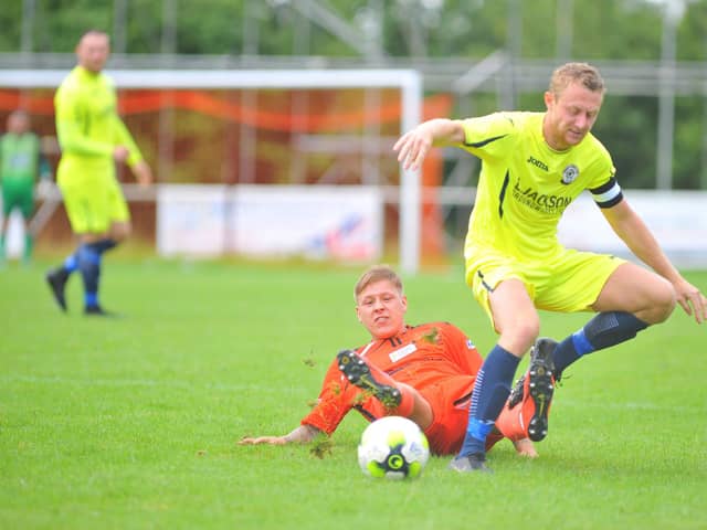 Portchester's Jake Raine, left, tackles Horndean skipper Ash Howes. Picture: Martyn White
