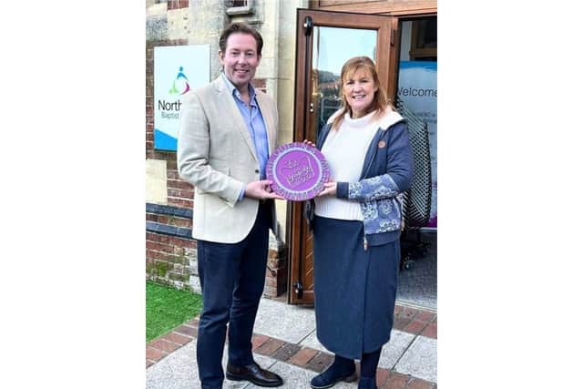 Cllr Chris Attwell, Portsmouth City Council's cabinet member for communities and central services, presents the first jubilee plaque to Reverend Tracey Ansell to mark the street party organised by North End Baptist Church in Powerscourt Road