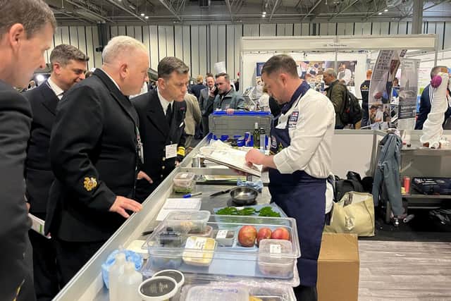 Visitors to the contest scrutinise the work of one of the Royal Navy's team of chefs