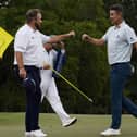 Justin Rose, right, is congratulated by Shane Lowry on the 18th hole after their first round at the Masters in Augusta. Picture: AP/David J. Phillip.