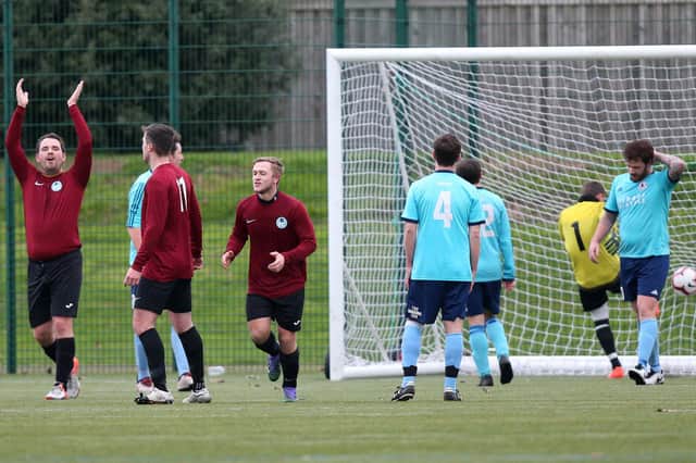 Harvey Herringshaw, third left, has just scored for Burrfields (maroon) against Portchester Rovers. Picture: Chris Moorhouse