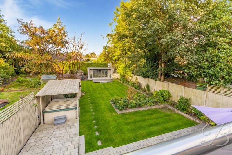 An aerial view of the back garden, complete with hot tub (left). That is sure to make a splash with potential buyers.