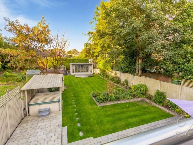 An aerial view of the back garden, complete with hot tub (left). That is sure to make a splash with potential buyers.