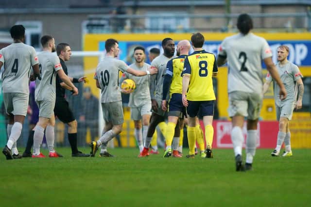 Tempers rise as Gosport's Mike Carter goes eyeball to eyeball with a Walton opponent. Picture: Chris Moorhouse